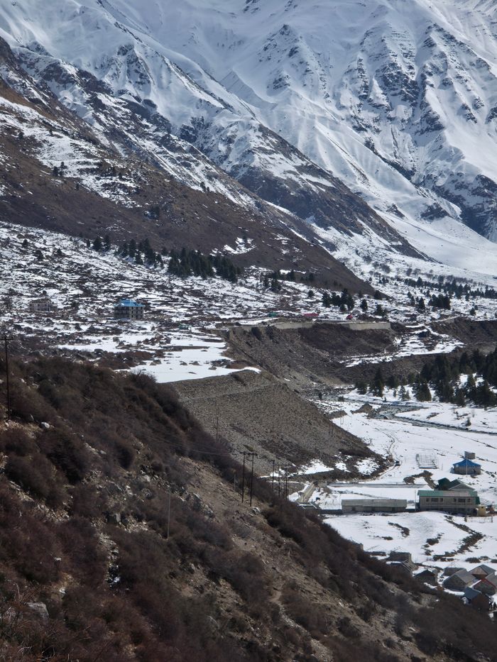 Scenic view of snow-covered mountains and valleys in Himachal Pradesh, India, showcasing nature's beauty.